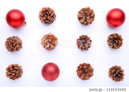 Christmas composition with pine cones and red christmas balls on white background Christmas composition with pine cones and red christmas balls on white background 114541640