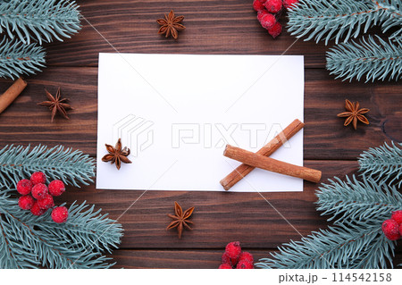 Christmas composition. Fir branches and berries of viburnum on a brown background 114542158