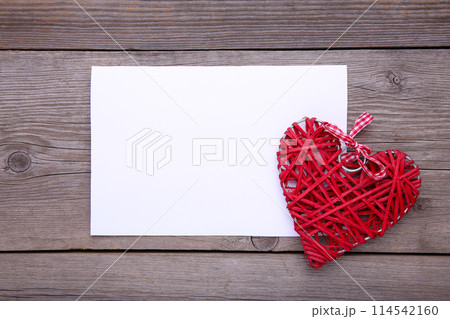 White paper with red heart on grey background 114542160