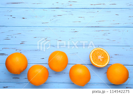 Ripe orange fruit on a blue background 114542275
