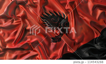 vibrant flag of Albania dances gracefully in the wind, showcasing its bold red background and distinctive black double-headed eagle symbol. 114543288