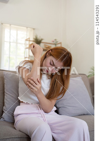 Asian woman have elbow pain, inflammation of tendon or ligament injury, overuse of arm muscles, Sore elbow or symptoms of rheumatoid arthritis 114543291