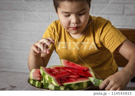 boy eating watermelon, a vibrant and rich source of Vitamin C boy eating watermelon, a vibrant and rich source of Vitamin C 114543933