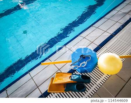 Resistant equipment - fins, swimming goggles, rescue board on the side near the pool. Preparing athletes for the Olympic Games, swimming. 114544609