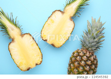 Pineapple and half of pineapple on a blue background Pineapple and half of pineapple on a blue background 114545392