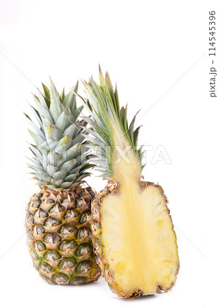 Pineapple and half of pineapple isolate on a white Pineapple and half of pineapple isolate on a white 114545396