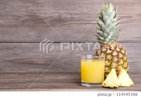 Fresh pineapple juice in the glass with slices Fresh pineapple juice in the glass with slices 114545398