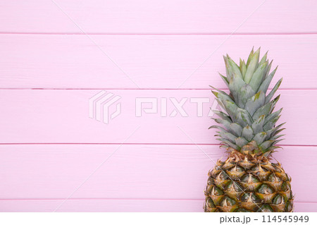 Ripe pineapple on a pink background with copy space Ripe pineapple on a pink background with copy space 114545949