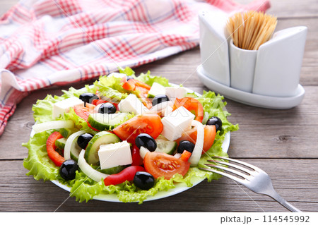 Fresh vegetable salad on grey wooden background 114545992