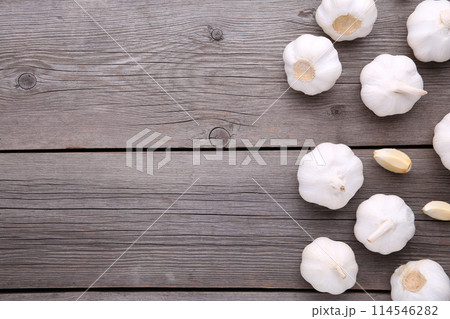 Fresh garlic on a grey wooden background Fresh garlic on a grey wooden background 114546282