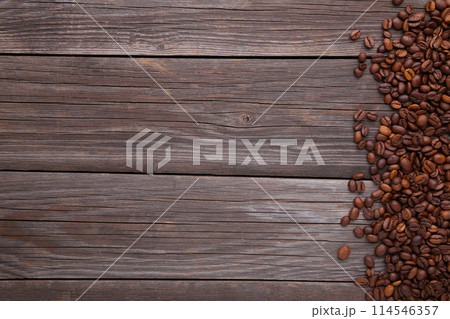 Natural coffee beans on grey wooden background Natural coffee beans on grey wooden background 114546357