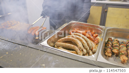 Grilled sausages for sale at winter market 114547503