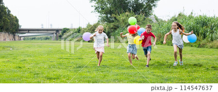 Children with balloons run in the summer park Children with balloons run in the summer park 114547637