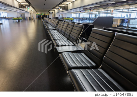 Empty airport terminal with black seats Empty airport terminal with black seats 114547883