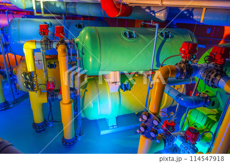 Colorful industrial tanks with control valves and gauges 114547918