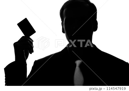 Portrait young man in suit, tie with plastic card - silhouette 114547919
