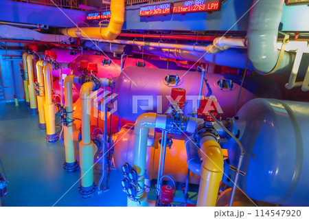 Colorful industrial tanks with control valves and gauges 114547920