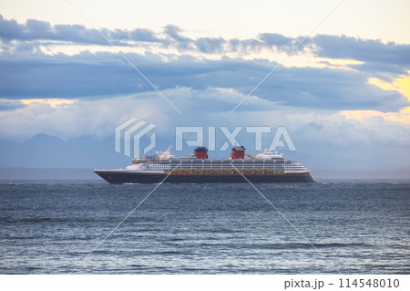 Large cruise ship passing by at sunset 114548010