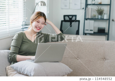Young woman working on laptop at home during the day. Work life balance concept 114548552