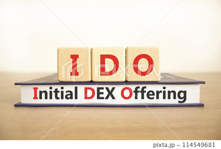 IDO initial DEX offering symbol. Concept words IDO initial DEX offering on beautiful wooden blocks and book. Beautiful white background. Business IDO initial DEX offering concept. Copy space. 114549681