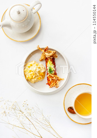 Light breakfast in a restaurant with green tea and pumpkin puree Light breakfast in a restaurant with green tea and pumpkin puree 114550144