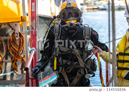 Commercial diver exiting water at harbor Commercial diver exiting water at harbor 114550836