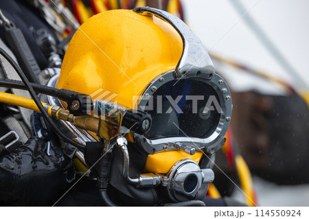 Closeup of diver holding commercial diving helmet Closeup of diver holding commercial diving helmet 114550924