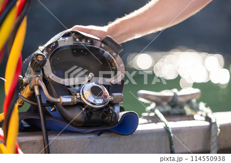 Closeup of commercial diving helmet on the boat 114550938