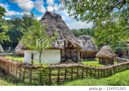 Amazing summer scene of traditional romanian peasant houses. Amazing summer scene of traditional romanian peasant houses. 114551263