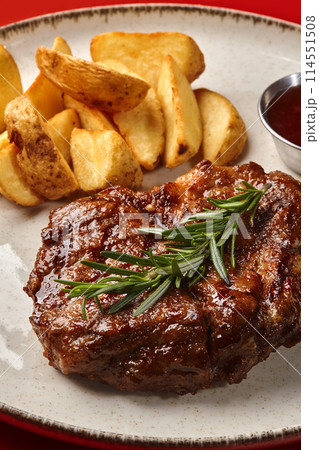Pork steak with country style potatoes and barbecue sauce 114551508