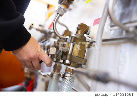 Man operating valves on hyperbaric chamber closeup 114551561