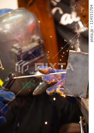 Closeup of welder working with sparks 114551704