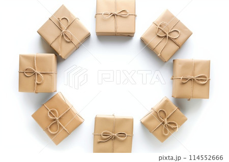 Flat lay of brown craft paper gift boxes with jute ties on a clean, white surface 114552666