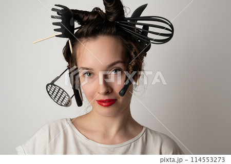 beautiful brunette housewife girl with kitchen utensils in her hair instead of curlers 114553273
