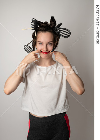 beautiful brunette housewife girl with kitchen utensils in her hair instead of curlers beautiful brunette housewife girl with kitchen utensils in her hair instead of curlers 114553274
