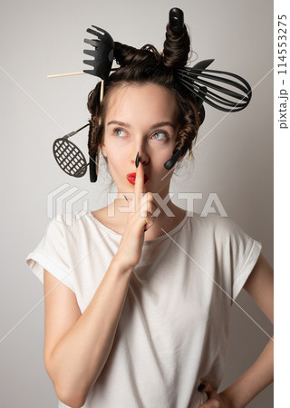 beautiful brunette housewife girl with kitchen utensils in her hair instead of curlers beautiful brunette housewife girl with kitchen utensils in her hair instead of curlers 114553275
