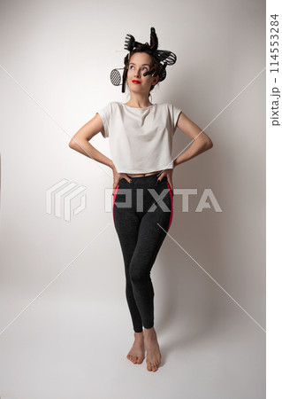 beautiful brunette housewife girl with kitchen utensils in her hair instead of curlers 114553284