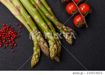 Sprigs of raw green asparagus as an ingredient for preparing a healthy breakfast 114553815