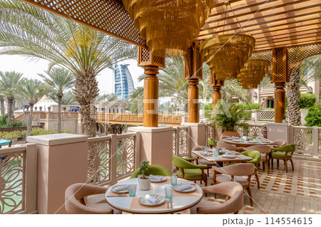 A restaurant with a view of the Burj al Arab in Dubai. 114554615
