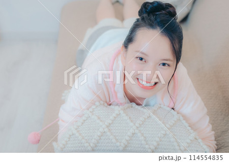 自宅のソファーに寝転ぶ若い女性 自宅のソファーに寝転ぶ若い女性 114554835