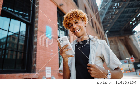 Watch the young man smiling in front of the real estate building facade Watch the young man smiling in front of the real estate building facade 114555154