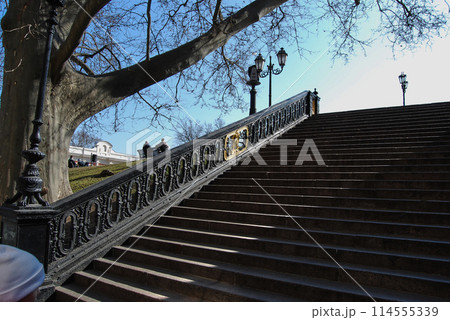 Stairs near the Opera House in Odessa.Beautiful staircase with wrought iron railings against the blue sky. 114555339