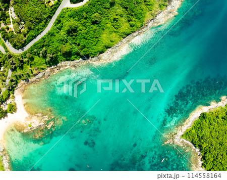 Aerial view Top down seashore background,Waves crashing on rock cliff, Beautiful dark sea surface in sunny day summer background, Amazing seascape top view seacoast at Phuket beach Thailand 114558164