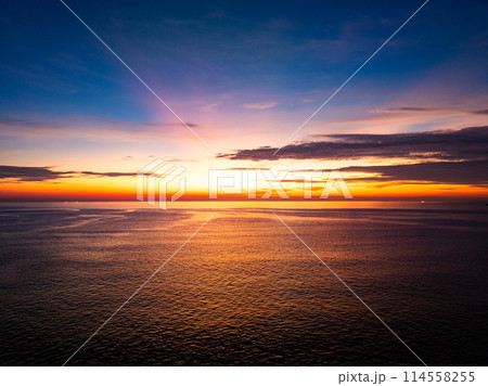 Aerial view sunset sky, Beautiful Light Sunset or sunrise over sea,Colorful dramatic majestic scenery sunset Sky, Amazing clouds and small waves in the ocean, Wonderful light cloud background 114558255
