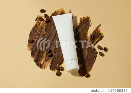 A thin layer of coffee-colored exfoliating cream on a light brown background, caffeine and antioxidants found in coffee beans help improve dull skin, making it firm and smooth. Mockup for advertising 114560385