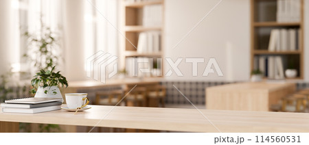 A wooden tabletop in a contemporary minimalist cafe co-working space or library reading room. 114560531