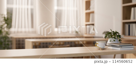 A space for displaying products on a wooden tabletop in a cozy contemporary library reading room. A space for displaying products on a wooden tabletop in a cozy contemporary library reading room. 114560652