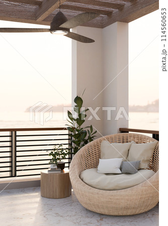 A cozy outdoor balcony lounge featuring a wicker lounge chair with pillows, and a nature view. A cozy outdoor balcony lounge featuring a wicker lounge chair with pillows, and a nature view. 114560653