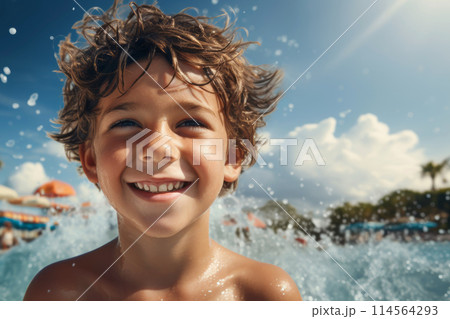 happy little boy in the pool at the aquapark on resort 114564293