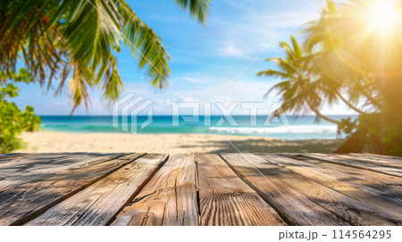 empty wooden table and landscape of beach with palms and ocean 114564295